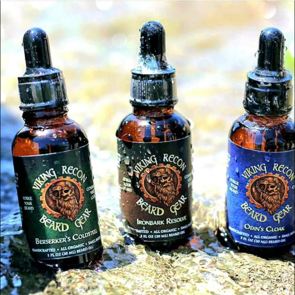 The three Viking Recon beard oils — Berserker's Coldsteel, Ironbark Resolve, and Odin's Cloak — in amber dropper bottles.